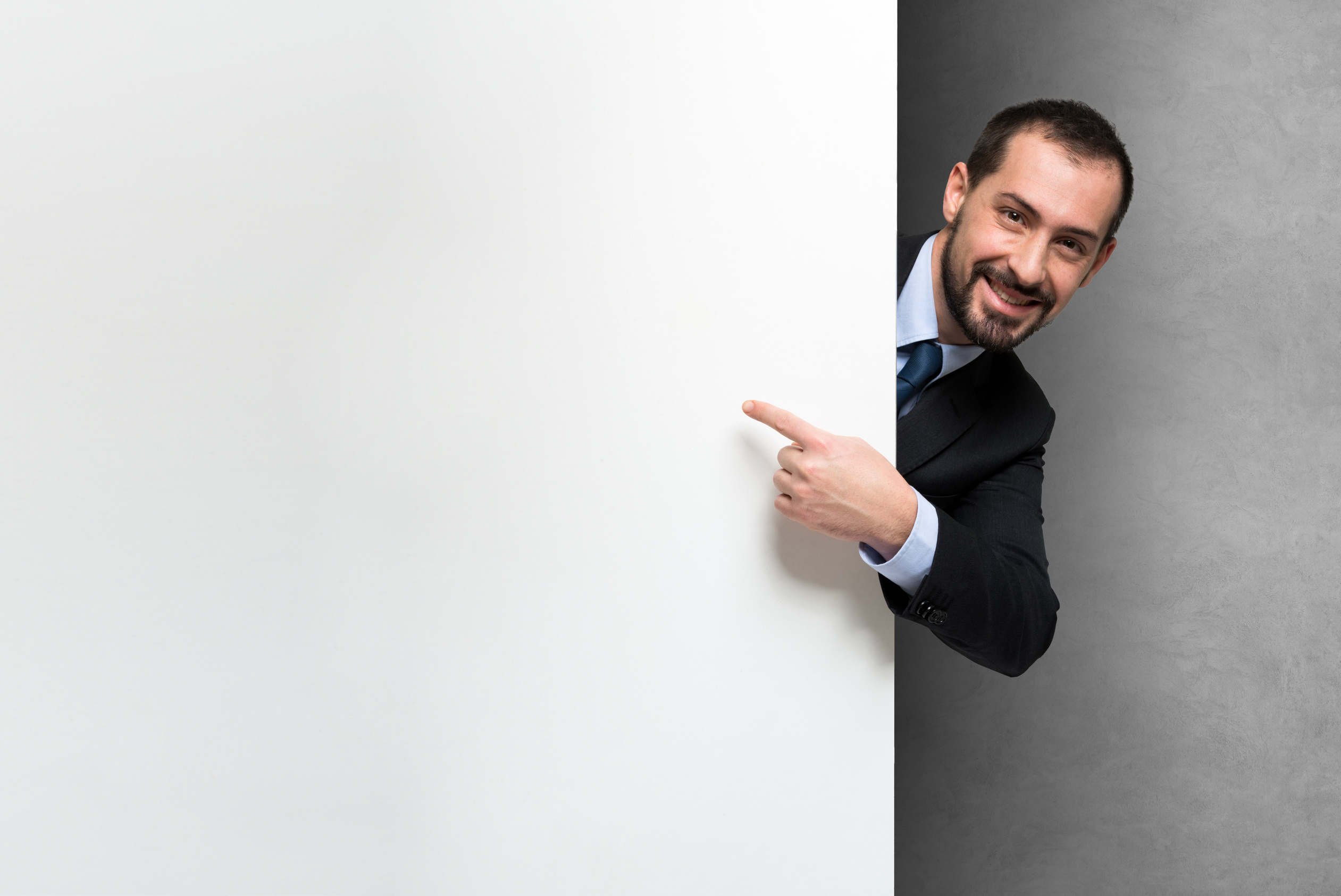 Smiling Businessman Holding a White Board